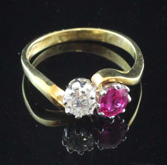 An 18ct gold, ruby and diamond set crossover ring, size Q.